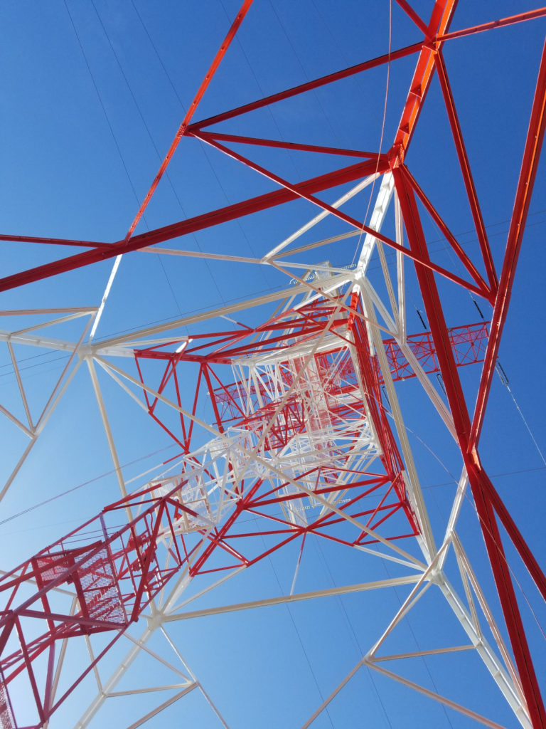 electrical transmission tower newly painted red and white for FAA regulations